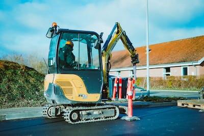 man operating a mini excavator